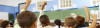 Rear view of a little school boy at his classroom kids-raised-hands-class-520x150